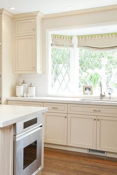 a kitchen with an oven, dishwasher and sink in it's center island