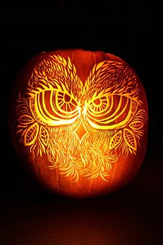 a carved pumpkin with an owl on it