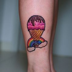 an ice cream cone with a rainbow on it