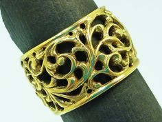 This intricate solid 14 karat filigree ring is 12 millimeters wide all the way around.  The intricate scrolls were all hand tooled using ancient goldsmithing techniques.  This ring is available in up to a size 6 for this listed price.  Please inquire for sizing price options. Elegant Wide Band Filigree Ring With Intricate Design, Gold Jewelry With Intricate Design And Wide Band, Gold Ornate Filigree Ring With Intricate Design, Ornate Gold Filigree Ring With Intricate Design, Ornate Yellow Gold Filigree Ring With Intricate Design, Ornate Engraved Yellow Gold Filigree Ring, Ornate Gold Engraved Ring With Filigree, Ornate Gold Engraved Filigree Ring, Ornate Gold Filigree Engraved Ring