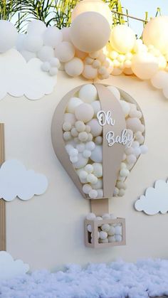 there is a hot air balloon on the wall with clouds and balloons in the background