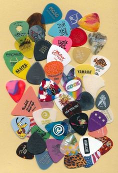 a pile of different colored guitar picks sitting on top of each other