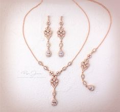 "Designed and created by me! All my jewelry is nickel free - hypoallergenic. Finish: Rose gold plated or Rhodium silver plated components Material: Top quality rhinestones, AAA Zirconia, lobster clasp. Please choose the Teardrop color from the color chart（see pic.10） Size of Teardrop: 14mm Color of Teardrop 1. Clear Zirconia 2. Peach Morganite 3. Aquamarine 4. Aqua Blue(out of stock) 5. Navy Blue 6. Emerald green 7. Silver Night Black(out of stock) 8. Teal Blue 9. Lavender Purple 10. Plum Purple Rose Gold Teardrop Bridal Necklace Gift, Wedding Jewelry With Teardrop Pendant And Adjustable Chain, Wedding Teardrop Pendant Jewelry With Adjustable Chain, Gold Sterling Silver Jewelry Sets For Wedding, Rose Gold Dangle Necklaces With Matching Earrings, Rose Gold Teardrop Jewelry Sets For Wedding, Rose Gold Teardrop Wedding Jewelry Sets, Wedding Rose Gold Dangle Necklaces, Rose Gold Sterling Silver Jewelry Sets For Wedding