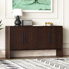 a living room with a large painting on the wall and a wooden cabinet in front of it