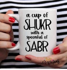 a woman is holding a coffee mug with the words, a cup of shur with a spoonful of saar