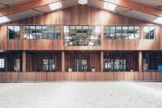 the inside of a large building with windows and wood paneling on the side of it