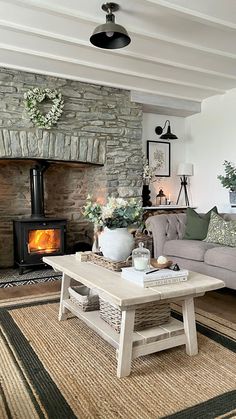 a living room filled with furniture and a fire place in the middle of the room