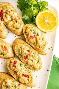 an image of crab cakes on a plate with lemons and parsley in the background