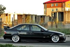 a black car is parked on the street