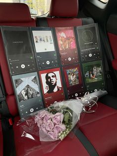 flowers and pictures are placed in the back seat of a car, along with an mp3 player