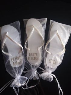 three pairs of bride's flip flops in clear bags