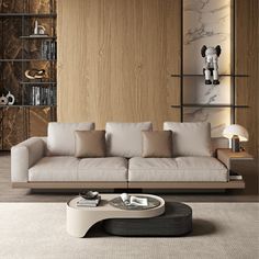 a living room with a couch, coffee table and bookshelf on the wall