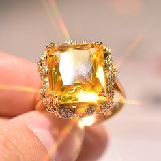 someone is holding a fancy yellow diamond ring