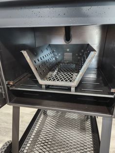 the inside of a grill with metal grates on it