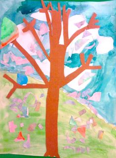 an art project made with colored paper and cut out pieces of paper, including a tree