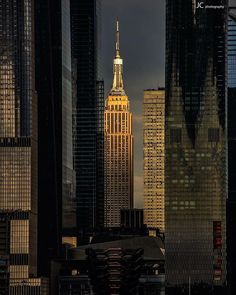 the empire building is lit up at night in new york city