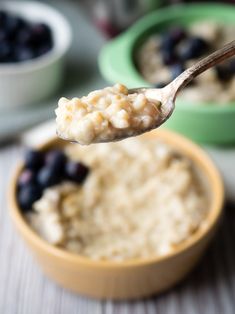 a spoon full of oatmeal with blueberries