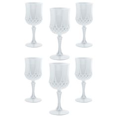 six white wine goblets sitting next to each other