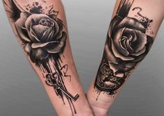 two black and white roses on both arms with scissors in the middle one is being held by another