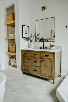 a bathroom vanity with two sinks and mirrors on the wall, along with other items