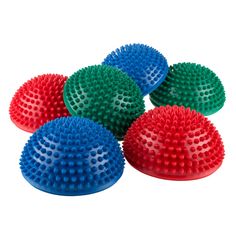 four different colored massage balls are arranged in the shape of pyramids on a white background