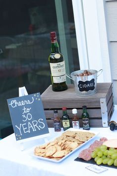 a table with wine, cheese and crackers on it