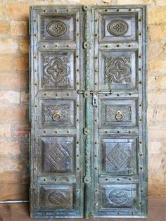 an old metal door with decorative designs on it