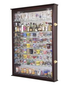 a wall mounted liquor display case filled with lots of bottles and glasses on it's side