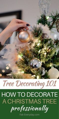 a woman decorating a christmas tree with white and green decorations on it, in front of