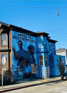 a large blue building with a mural on it's side