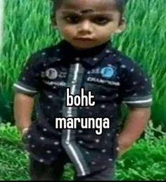 a little boy that is standing in the grass with words above him saying, boht marunga