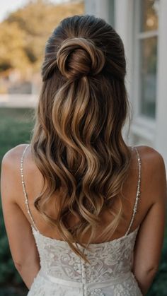 the back of a woman's head wearing a wedding dress