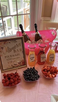 a table topped with fruit and drinks next to a sign that says muncha bar