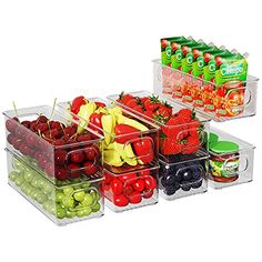 plastic containers filled with fruits and vegetables on top of each other next to juice bottles