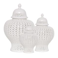 three white ceramic vases with lids on them