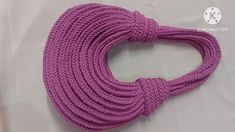 a purple rope is shown on a white sheet