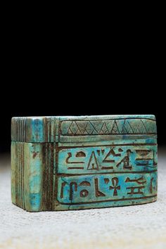 an ancient egyptian hieroglyphic type box with writing on it's sides