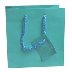 "Shipping to the Lower 48 US States only. Alaska Hawaii, PR, US Territories and APO addresses to contact us for actual shipping costs. Sold in Qty 100 Bags Gloss laminated art paper tote bag with a matching braided rope handle. This beautiful bag makes your packaging perfect when paired with tissue paper and a bow! Jewelry not included. Color: Teal Blue Size: Measures 6.5 \" x 3.5\" x 6.5\" tall. Product note: Make your packaging shine with glossy euro totes! Material: Teal paper" Light Blue Pouch Bag As Gift, Light Blue Pouch Bag For Gift, Blue Pouch Box Bag For Shopping, Blue Box Bag Pouch For Shopping, Blue Box Bag For Shopping, Blue Square Box Bag With Top Carry Handle, Blue Pouch-shaped Gift Bag, Light Blue Rectangular Shoulder Bag For Gift, Light Blue Rectangular Shoulder Bag As Gift