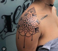 a woman with a tattoo on her shoulder