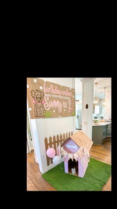 a dog house with a birthday sign on the wall