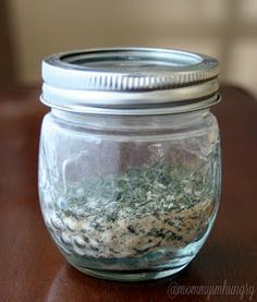 a glass jar filled with food sitting on top of a wooden table