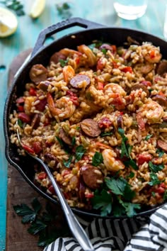 a skillet filled with rice and sausage