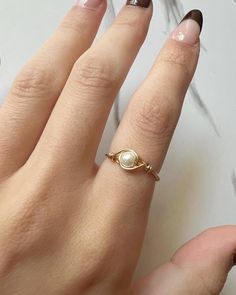 Dainty Pearl ring! All wire rings are sized just for you! Choose between gold and silver wire! Check out my other listings on my instagram for giveaways and product reveals! Orders can be made on my instagram for possible bundles at a lower cost! instagram.com/veefloraa Handmade in Fort Worth, Texas. Depending on inventory/already made pieces, processing time can range from 1-4 days plus shipping time. (USPS ranges from 3-5 business days) Rings are final sale and cannot be exchanged for differen Wire Pearl Ring, Unique Wire Rings, Moti Ring Design For Women, Delicate Pearl Ring, Moon Goddess Jewelry, Pearls Rings, Wire Wrap Ring