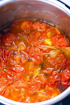 tomatoes are simmering in a pot on the stove