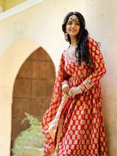 Red Angrakha Anarkali Kurti with palazzo and chanderi dupatta, has a v-neck and full-length sleeves, embellished with hand block printing work all over. Neck: Angarakha Neck Sleeve Length: 3/4th Sleeve Kurta Length: Ankle Length Fabric: Kurta & Bottom - Cotton Dupatta - Chanderi Note: Wash Care Instructions - Dry Clean Only. The product will be shipped within 15-20 days of the order placed Measurements: Size Bust Waist Hip XS 34 28 36 Size 36 30 38 M 38 32 40 L 40 34 42 XL 42 36 44 2XL 44 38 46 Anarkali Sets With V-neck For Festivals, Traditional V-neck Salwar Kameez With Printed Motifs, Anarkali Style Mulmul Palazzo Set For Navratri, Festive V-neck Kurta With Block Print, Chanderi Block Print Churidar With Long Sleeves, Long Sleeve Chanderi Churidar With Block Print, Traditional Floor-length Sets With Printed Motifs, Festive Straight Kurta Salwar Kameez With Block Print, Festive Straight Kurta Churidar With Block Print