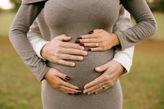 a pregnant woman with her hands on her stomach