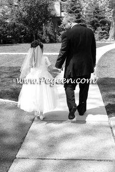 the bride and groom are walking down the sidewalk