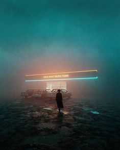 a man standing in the middle of a body of water under a neon lit sign