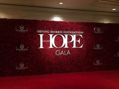 a red carpeted wall with the words hope gala written on it