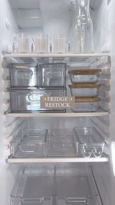 an open refrigerator with plastic containers on the shelves